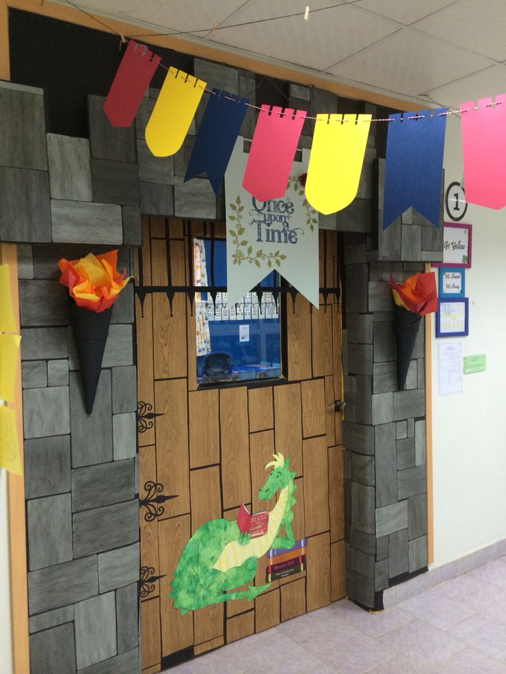 an office decorated with paper cutouts and flags hanging from the ceiling over a door