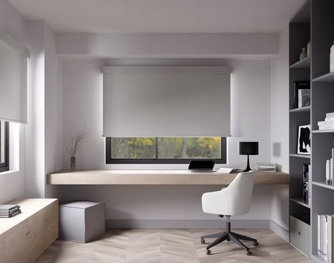 an office with a desk, bookshelf and window in the middle of it