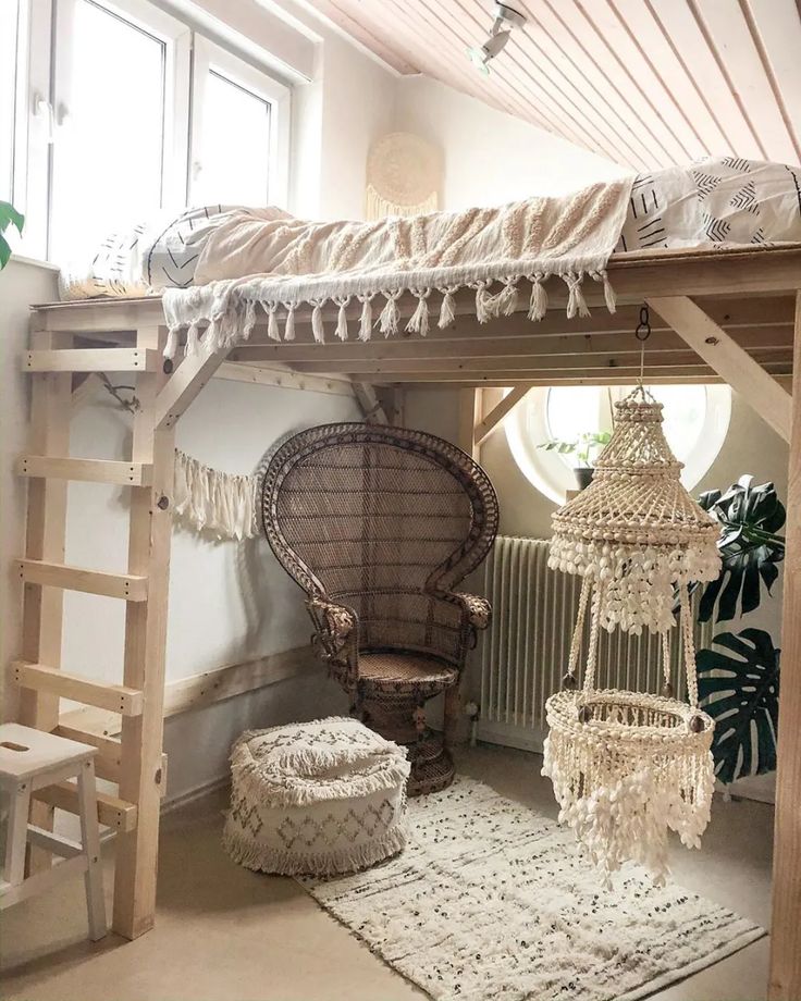 a room with a bed, chair and chandelier hanging from it's ceiling