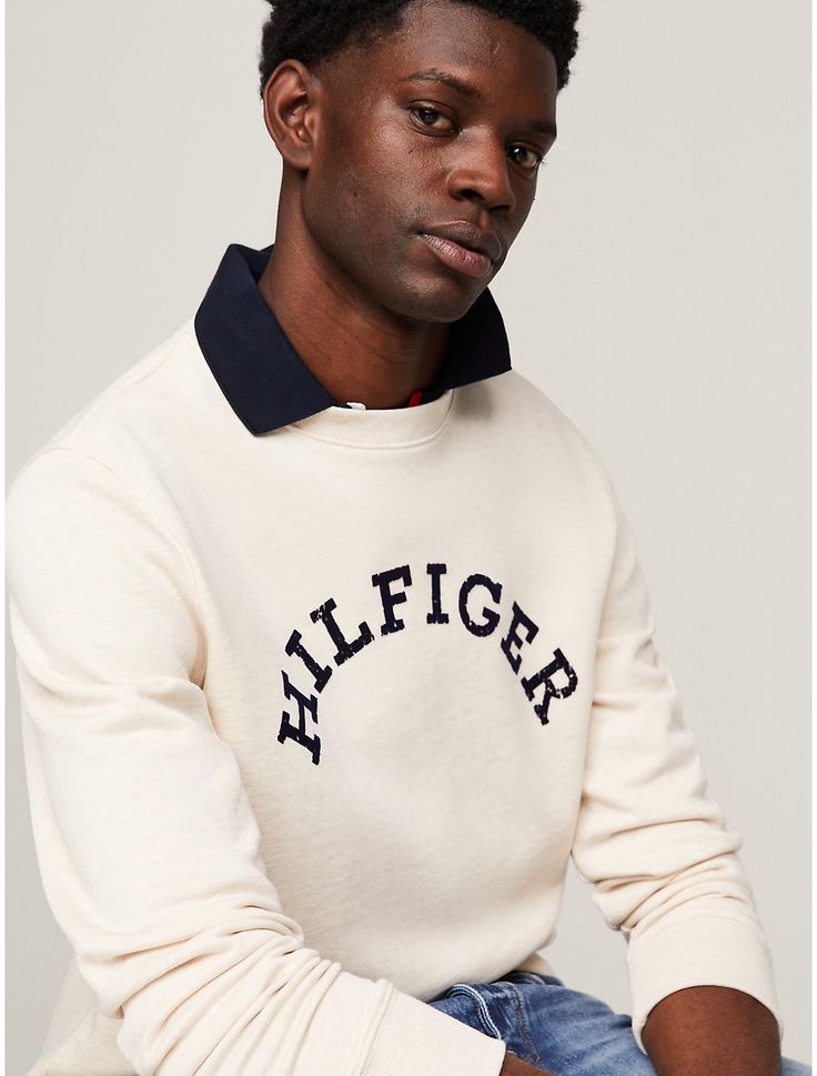 Tommy Hilfiger men's sweatshirt. For chilly days or lounging around, reach for this cozy sweatshirt made from heavy French terry cotton printed with our arched Hilfiger logo on the chest.  Material: 61% Cotton (rgc), 39% Transitional Cotton ,  In-conversion. Winter Loungewear Sweatshirt With Logo, Winter Loungewear Sweats With Embroidered Logo, Tommy Hilfiger Winter Sweatshirt With Ribbed Cuffs, Tommy Hilfiger Cotton Crew Neck Hoodie, Winter Tommy Hilfiger Sweatshirt With Letter Print, Tommy Hilfiger Letter Print Winter Sweatshirt, Tommy Hilfiger Letter Print Sweatshirt For Winter, College Logo Detail Sweatshirt For Fall, Tommy Hilfiger Sporty Winter Sweatshirt