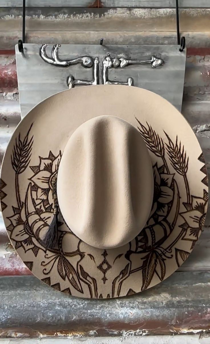 a cowboy hat hanging on a wall