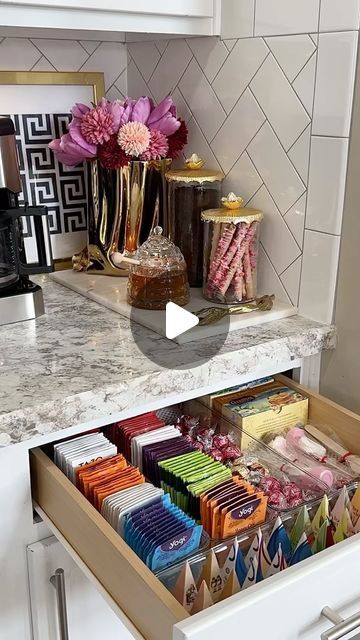 an open drawer in the middle of a kitchen counter with candy bars and candies