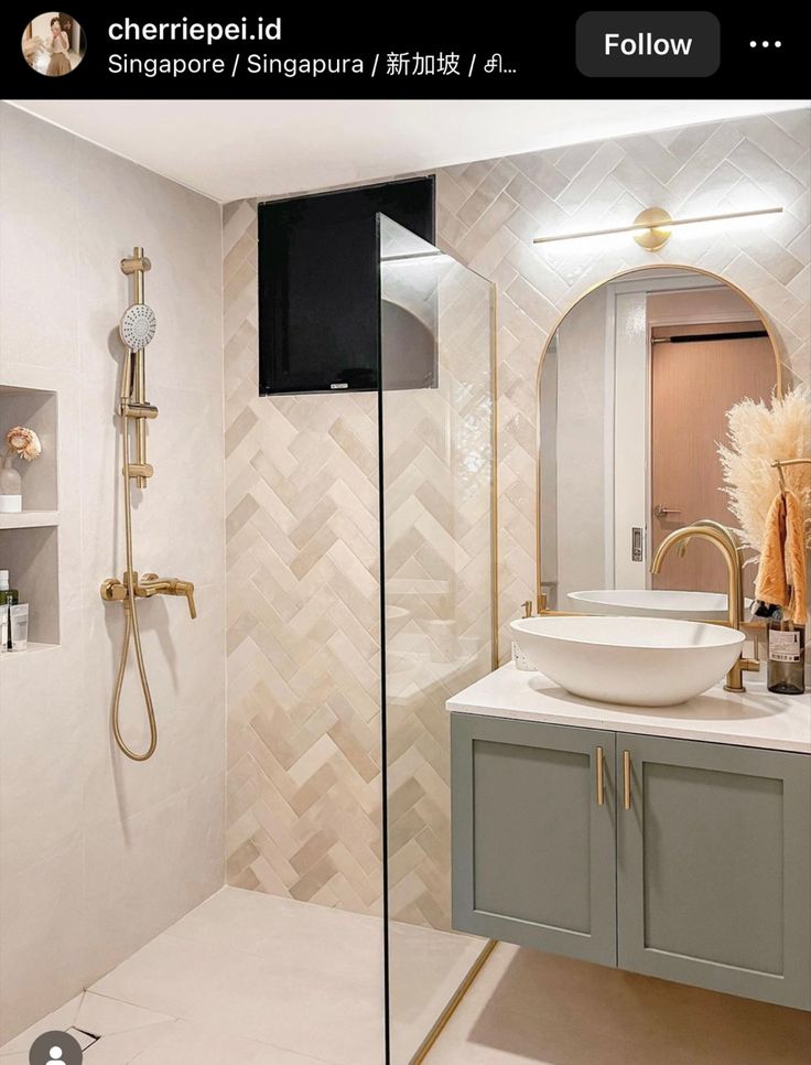 a bathroom with a sink, mirror and shower head in the corner next to it