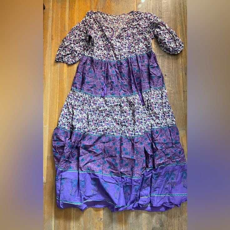 This Is A Gorgeous Natural Life Dress In Medium. It’s Purple And It’s Some Tan, Pink, And Teal, Looks Amazing On Its Own Or As A Swimsuit Cover Up. I Had Visions Of Wearing It With A Denim Jacket, Hoop Earrings And Flip Flops But I’m Too Short. I’m 5’ And The Dress Hits Me At The Tops Of My Feet, I Have To Hold The Dress Up If I’m Walking Up/Down Stairs So I Don’t Trip. It’s Beautiful Though! For The Record, I Only Tried This On, It’s Brand New, The Tag Came Off When I Tried It On. Smoke Free Ho Purple Cotton Beach Dress, Purple Cotton Printed Dresses, Printed Cotton Purple Dresses, Purple Printed Cotton Dress, Purple Floral Print Tunic Dress, Purple Flowy Tunic Dress, Bohemian Purple Cotton Maxi Dress, Purple Bohemian Tunic Dress, Bohemian Purple Tunic Dress