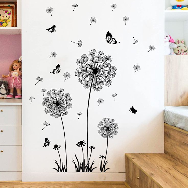 a wall with dandelions and butterflies on it in a child's room