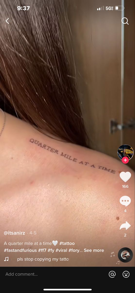 the back of a woman's neck with tattoos on it