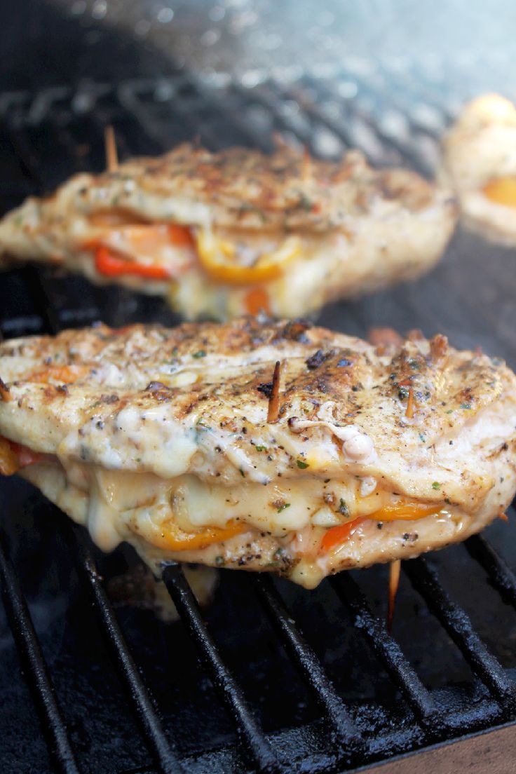 grilled chicken on the grill with cheese and peppers over it is an advertisement for grilled chicken