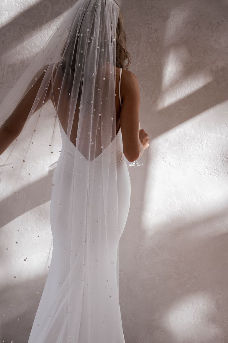 a woman in a white wedding dress and veil