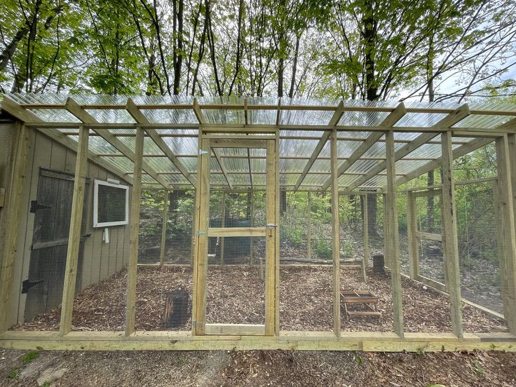 a chicken coop in the middle of some trees