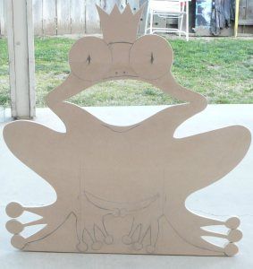 a cardboard cut out of a frog with a crown on it's head