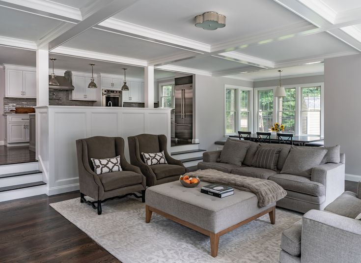 a living room with couches and chairs in it