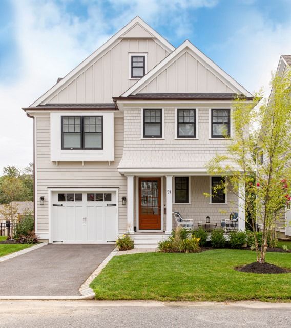 a two story house with white siding and brown trim on the front door is shown