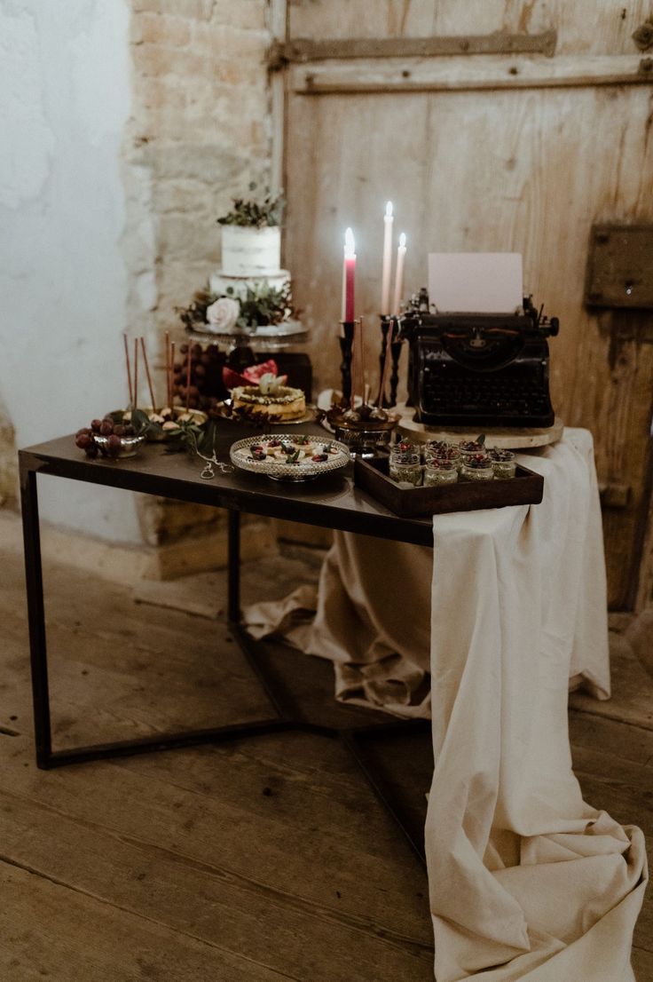 a table topped with lots of food and candles