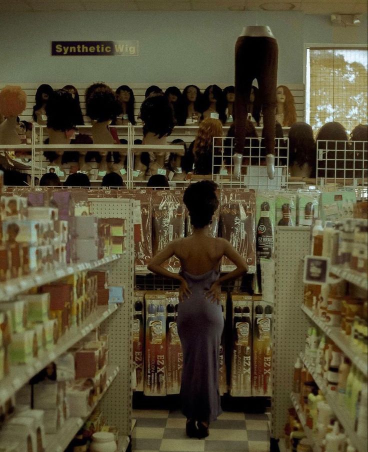 a woman is standing in the aisle of a store with her back to the camera