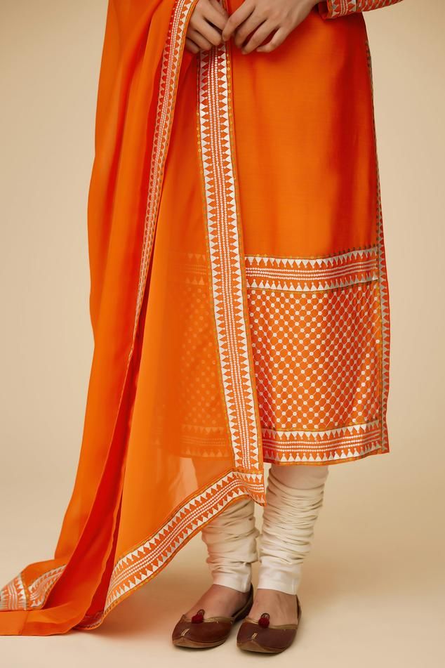 Tangerine orange long sleeves A-line kurta in chanderi base with round neckline and floral tonal jaal sequin embroidery. Paired with ivory churidar and floral aari work with sequin highlights viscose organza dupatta.
Components: 3
Pattern: Embroidery
Type Of Work: Aari Work With Sequins and Zari
Neckline: Round
Sleeve Type: Long
Fabric: Kurta: Chanderi, Dupatta: Viscose Organza, Churidar: Cotton
Color: Orange
Other Details: 
Length:
Kurta: 46inches
Churidar: 58inches
Dupatta: 2.5metres
Occasion: Semi-stitched Orange Churidar With Zari Work, Semi-stitched Orange Salwar Kameez With Zari Work, Designer Orange Dupatta With Resham Embroidery, Navratri Long Sleeve Salwar Kameez With Embroidered Border, Designer Orange Dupatta For Festivals, Designer Festival Orange Dupatta, Semi-stitched Orange Chanderi Salwar Kameez, Orange Semi-stitched Churidar With Dupatta, Traditional Unstitched Orange Salwar Kameez