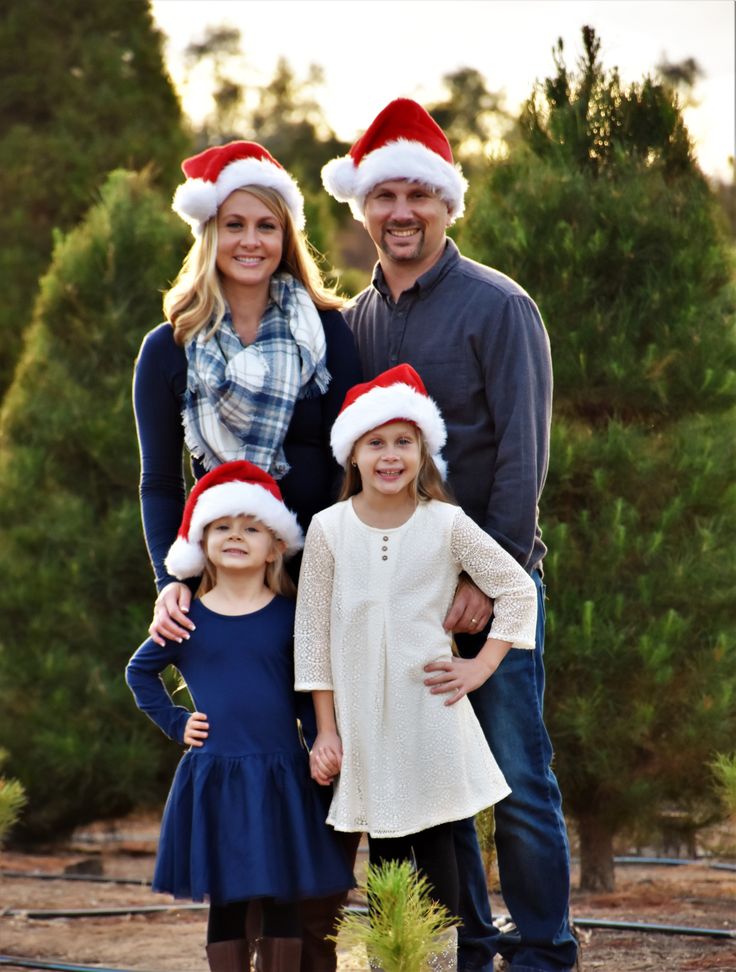 a family wearing christmas hats posing for a photo