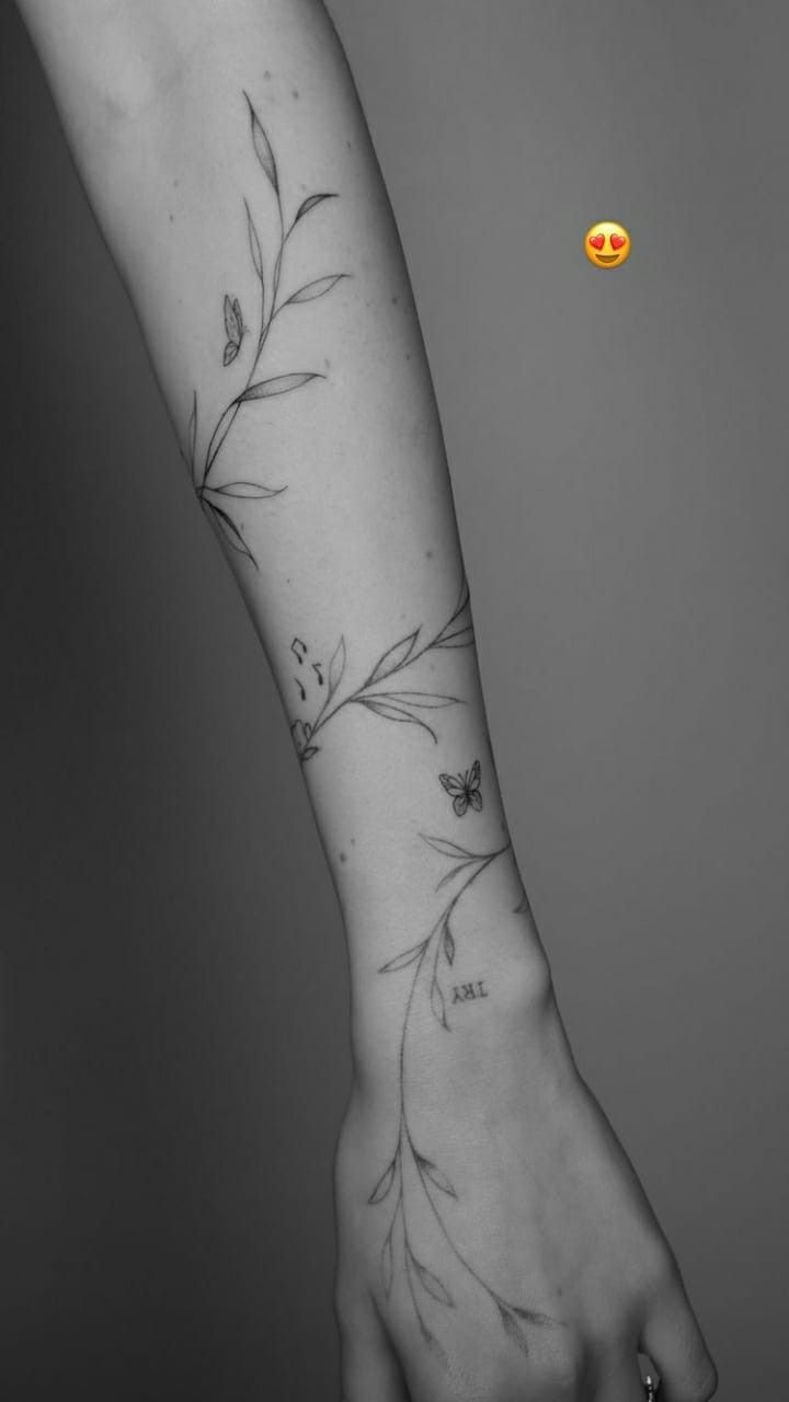 a woman's arm with flowers on it