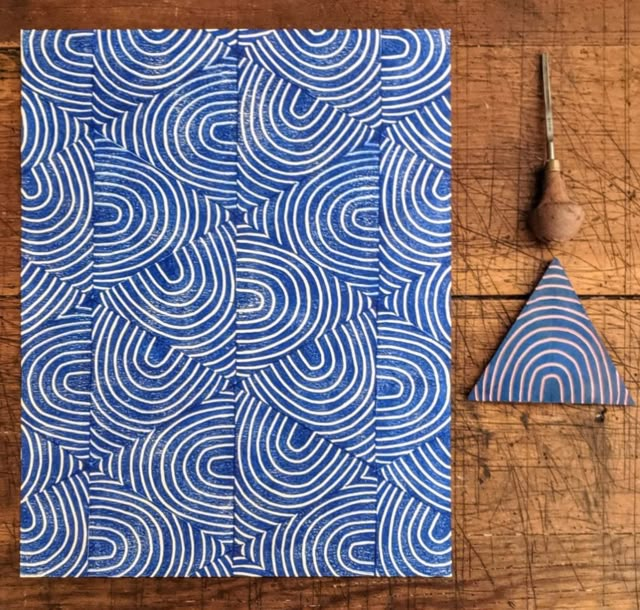 a piece of paper with blue swirls on it next to a pair of scissors