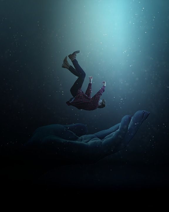 two people are floating in the water with their hands