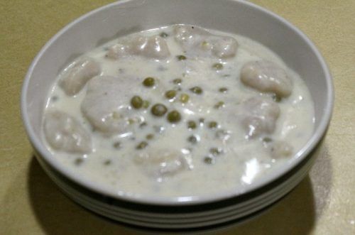 a white bowl filled with food on top of a table