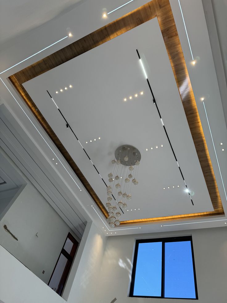 the ceiling in this room is made of wood and white with lights hanging from it