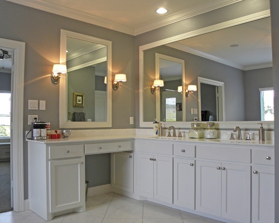 a large bathroom with double sinks, mirrors and lights on the ceiling is shown in this image