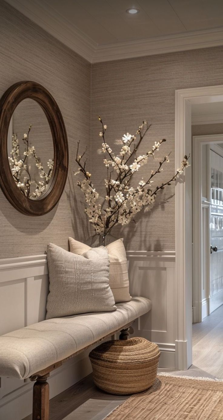 a white bench sitting next to a doorway with a vase on top of the bench