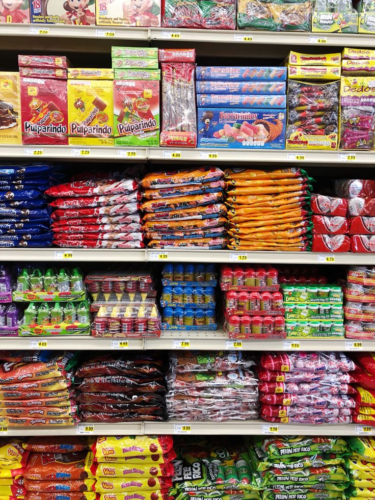 a store shelf filled with lots of different types of snacks and drinks on display for sale