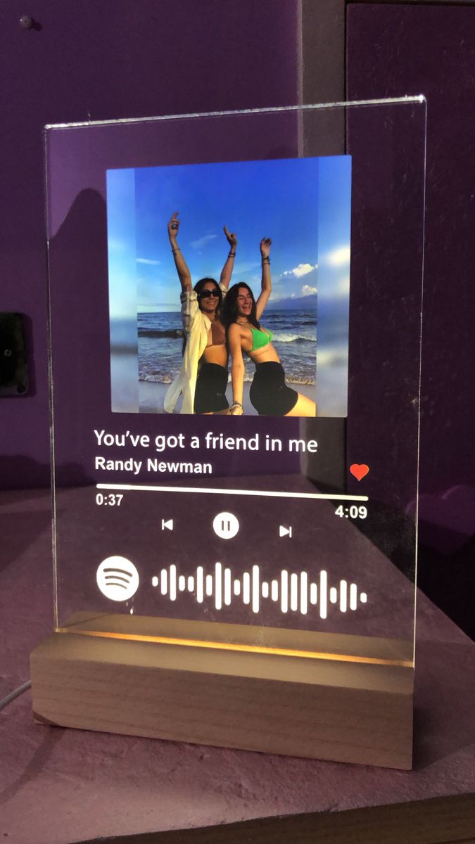 a glass block with an image of two people on it and the words you've got a friend in me