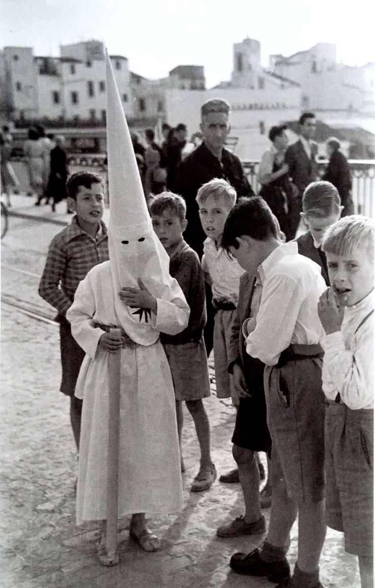 a group of children standing around each other