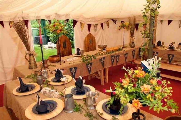 the tables are set up for an outdoor event with flowers in vases on them