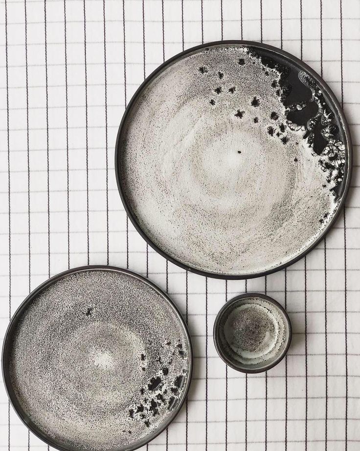 two black and white plates sitting on top of a table