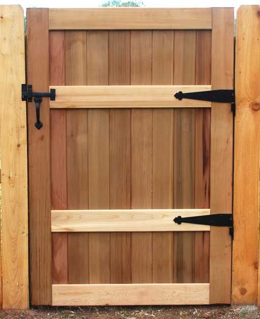 an image of a wooden gate with black handles