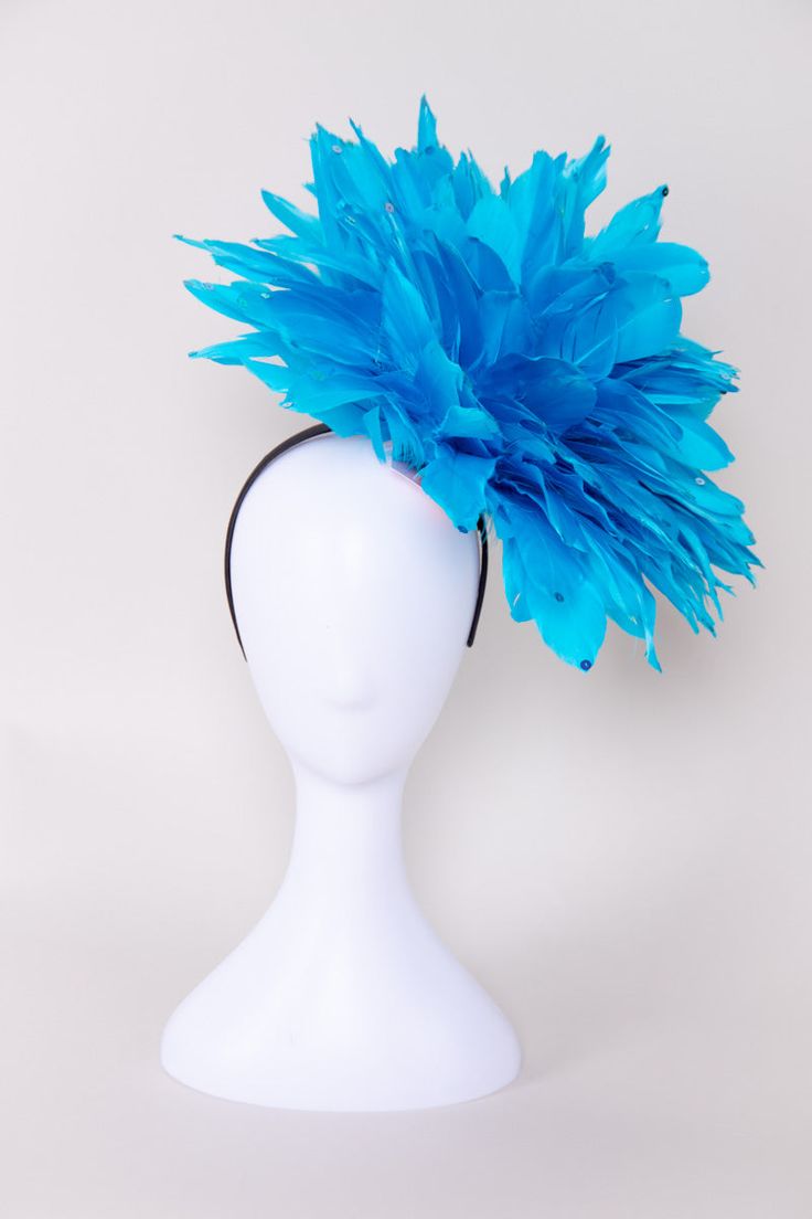 Get ready to party when you wear this fun and fluffy fascinator! Covered in solid bright red-colored feathers and accented with sequins. Pair this with a dress, jumpsuit, or romper for your next event! NO RETURNS/EXCHANGES due to the nature of the product (special occasions and headwear). Not all screens/lighting are created equal. Make sure you are happy with the color match before ordering! If you have any concerns, let us know! All Sales Final on Hats and Fascinators. Colors will vary with di Spring Party Feather Trim Fascinator, Ostrich Feather Headpiece For Kentucky Derby Party, Ostrich Feather Headpieces For Kentucky Derby Party, Kentucky Derby Ostrich Feather Headpiece For Party, Summer Party Feather Trim Fascinator, Summer Party Fascinator With Feather Trim, Light Blue Headpiece For Royal Ascot Party, Spring Party Headpieces With Feathers, Carnival Party Fascinator With Feather Trim