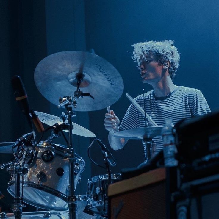 a young man playing drums on stage