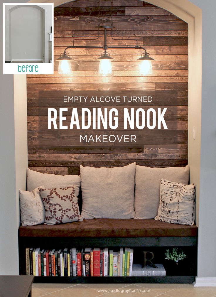 an empty reading nook with pillows and books on the shelf in front of it