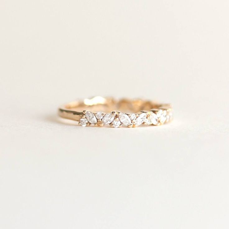 a gold wedding band with five pear shaped diamonds