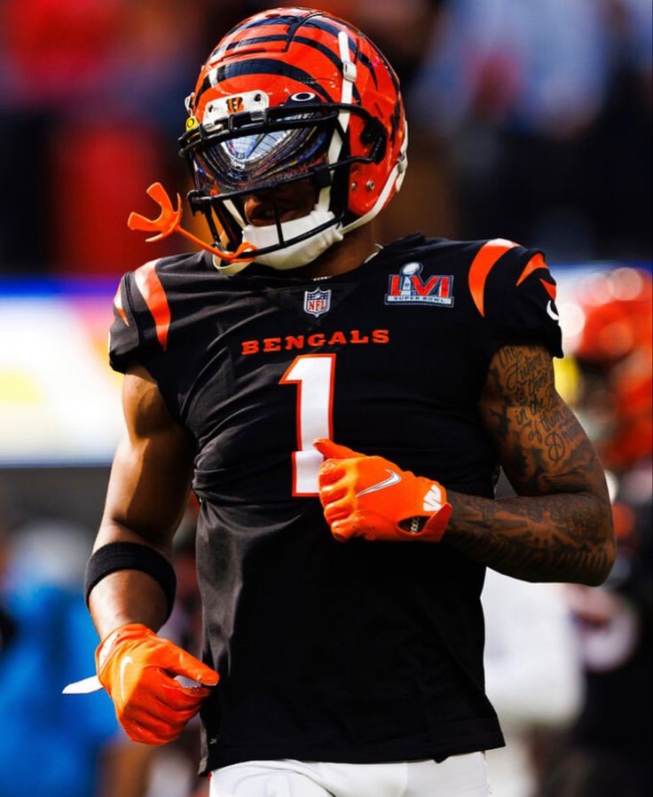 a football player wearing an orange and black uniform