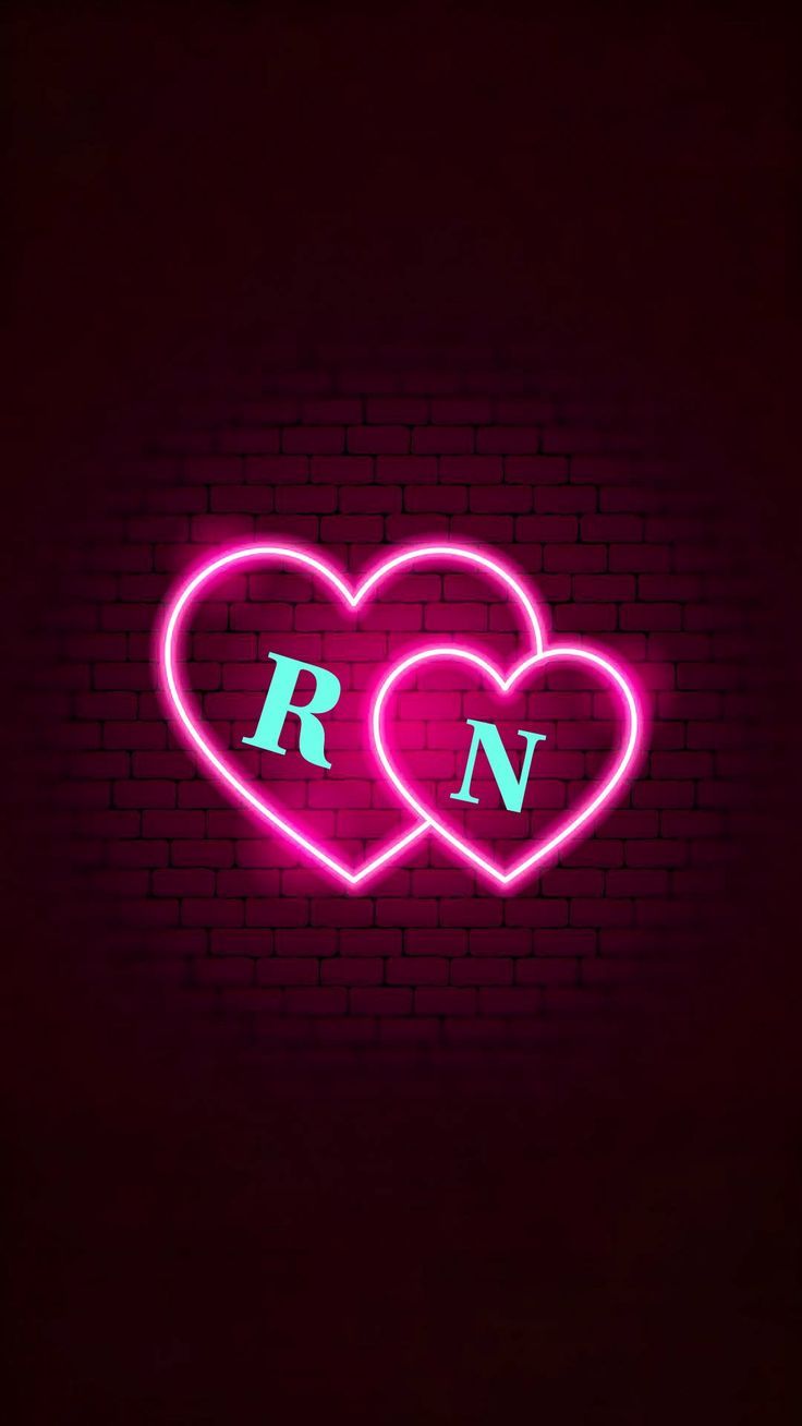 two neon hearts with the letter n on them in front of a dark brick wall