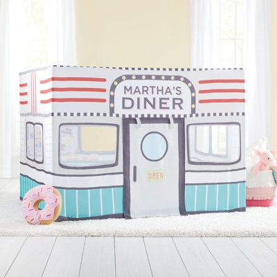 a play tent with a donut on the floor in front of it that says martha's diner