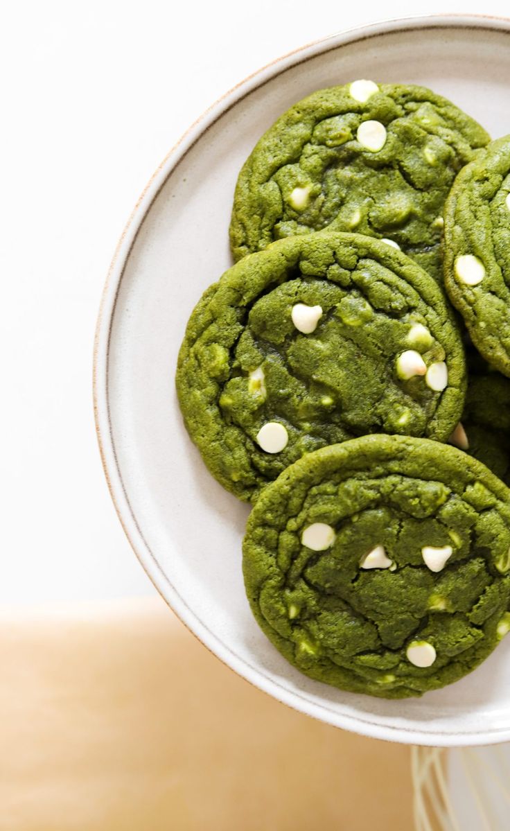 green cookies with white sprinkles on a plate