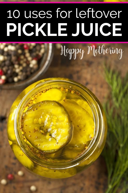 a jar filled with pickle juice next to some herbs and peppercorst on a wooden table