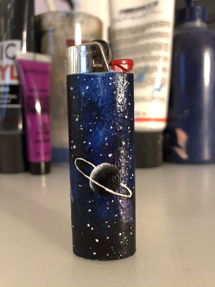 a lighter that is sitting on top of a table in front of some other items