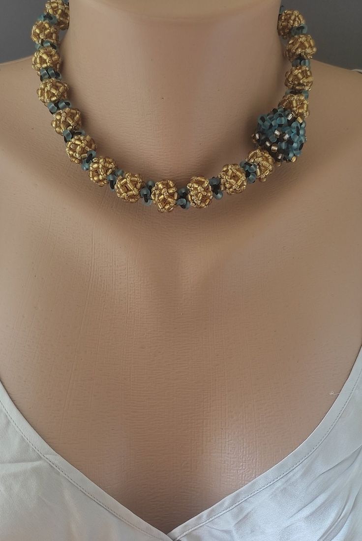 "A golden honey color is the main color of this lovely piece (both from the beads and the synthetic thread) with hints of frosted blue and black cord throughout that truly make those colors pop.     Elegant, classy and unusual, perfect for a special night out to accompany that perfect dress. - Approx. 17\"(42 cm) in L - Contains approx. 2 grams of sterling silver" Elegant Gold Choker With Colorful Beads, Gold Choker With Round Beads For Parties, Unique Gold Beaded Necklaces With Spacer Beads, Gold Choker With Large Beads For Gift, Gold Choker With Large Beads As Gift, Unique Gold Beaded Choker, Unique Gold Beaded Necklaces For Party, Gold Faceted Beads Choker As Gift, Gold Choker With Faceted Beads For Gift