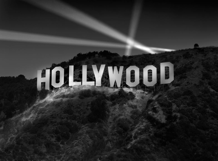 hollywood sign with five gold stars in front of the hollywood sign that says, in the shadow of the hollywood sign