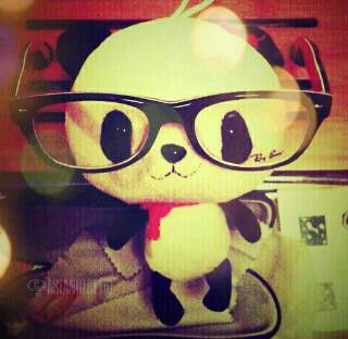 a stuffed animal wearing glasses and a red tie