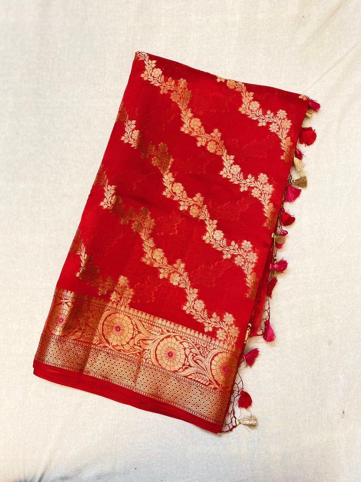 Showcasing a red colour Chiniya Silk saree, this saree is a masterpeice, hardwork of weavers are clearly visible in this, artistry of designer weaves to make the saree in checks pattern and fill it up with multicolour threads floral abstract,  This saree comes with a multiple colour contrasting Resham tassels.  Length: 6.5 mtr saree including 1mtr blouse peice Red Tussar Silk Pre-draped Saree With Motifs, Bollywood Style Tussar Silk Pre-draped Saree With Motifs, Art Silk Pre-draped Saree With Pallu For Rituals, Traditional Tussar Silk Pre-draped Saree, Traditional Festive Slub Silk Pre-draped Saree, Traditional Handloom Pre-draped Saree For Diwali, Traditional Red Slub Silk Pre-draped Saree, Traditional Designer Pre-draped Saree, Chanderi Pre-draped Saree With Motifs For Puja