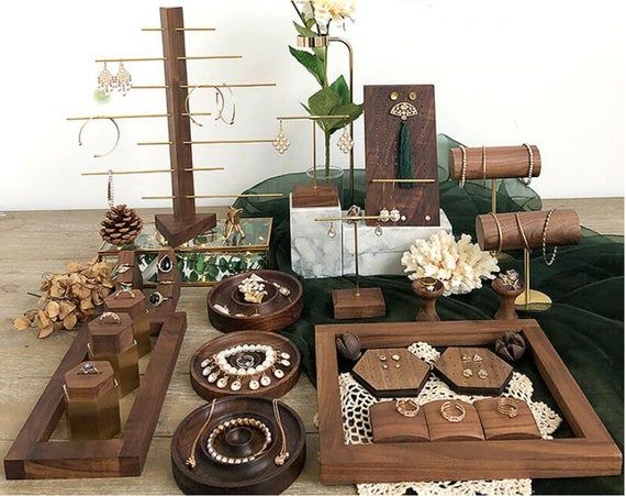 a table topped with lots of wooden boxes filled with jewelry