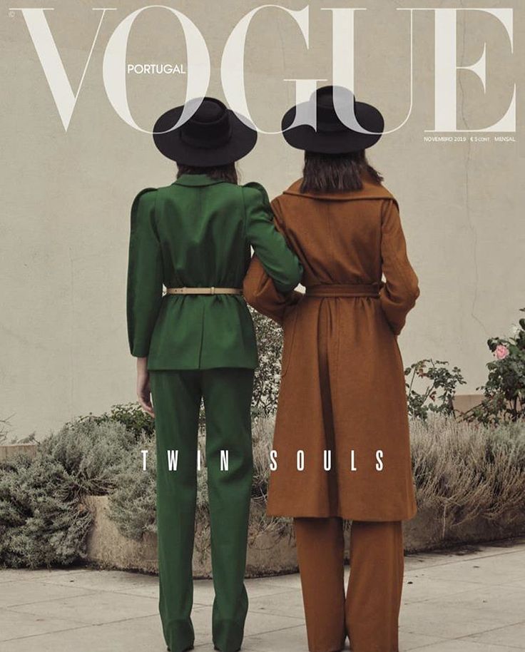 two people in green and brown outfits standing on the cover of a magazine, facing each other