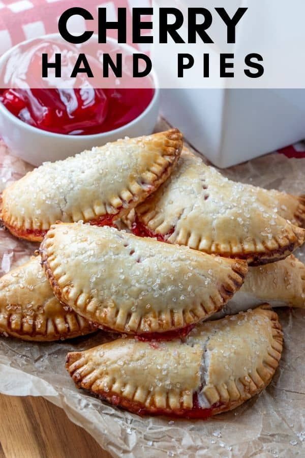 several small pastries are on a piece of wax paper next to a bowl of ketchup